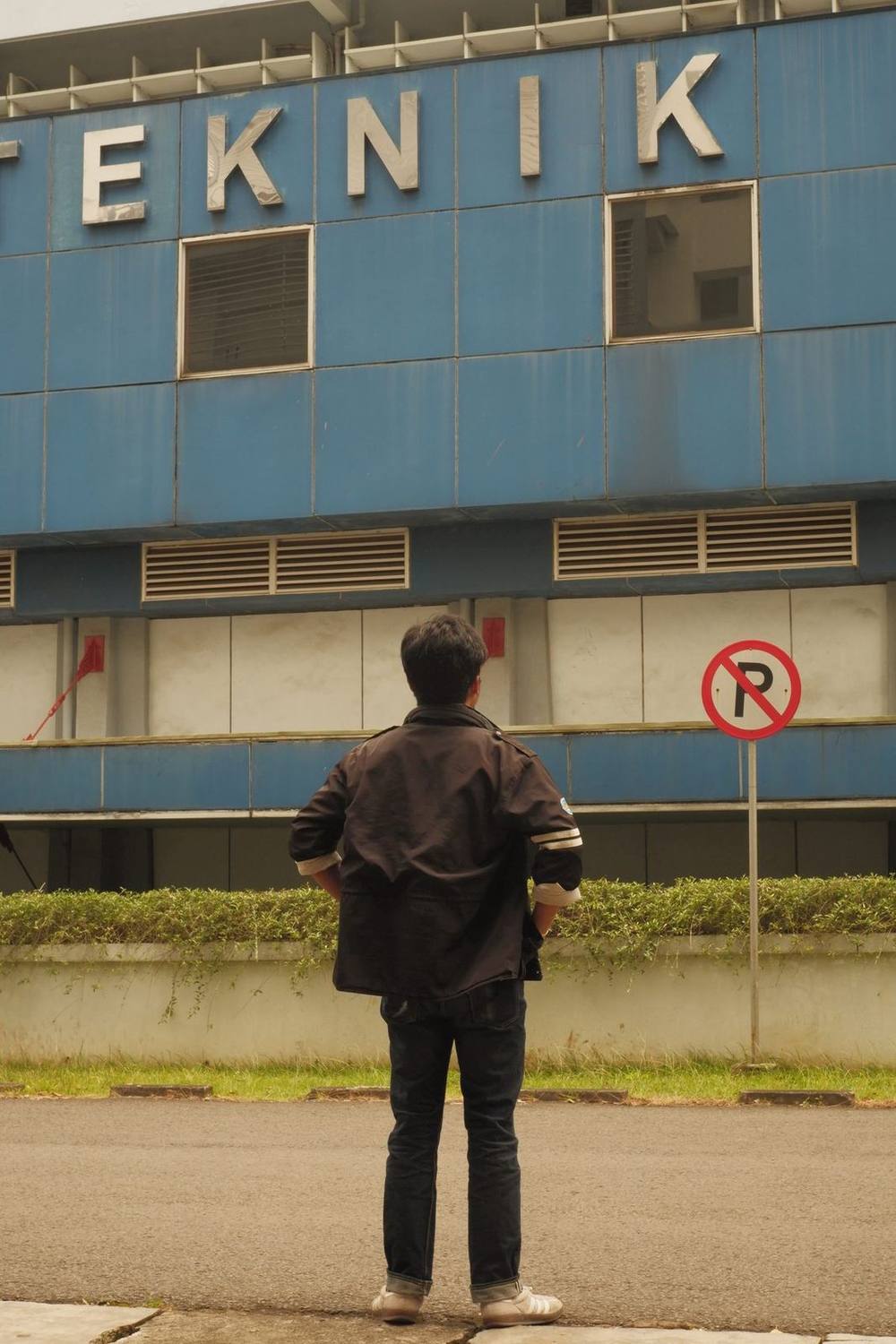 A student standing before the ITB Engineering building