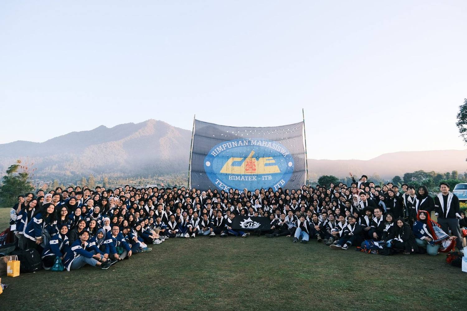 HIMATEK-ITB members gathered for a group photo with a mountain backdrop