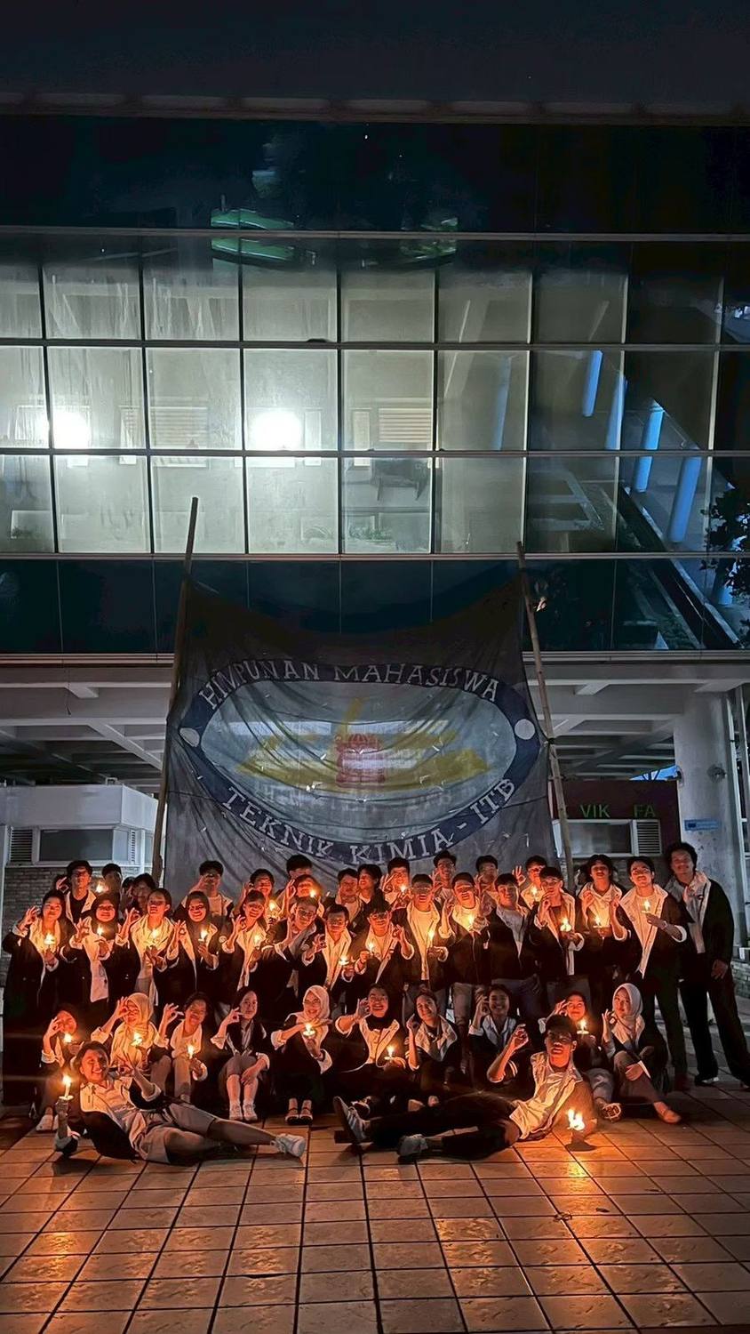 Members gathered with candles at night